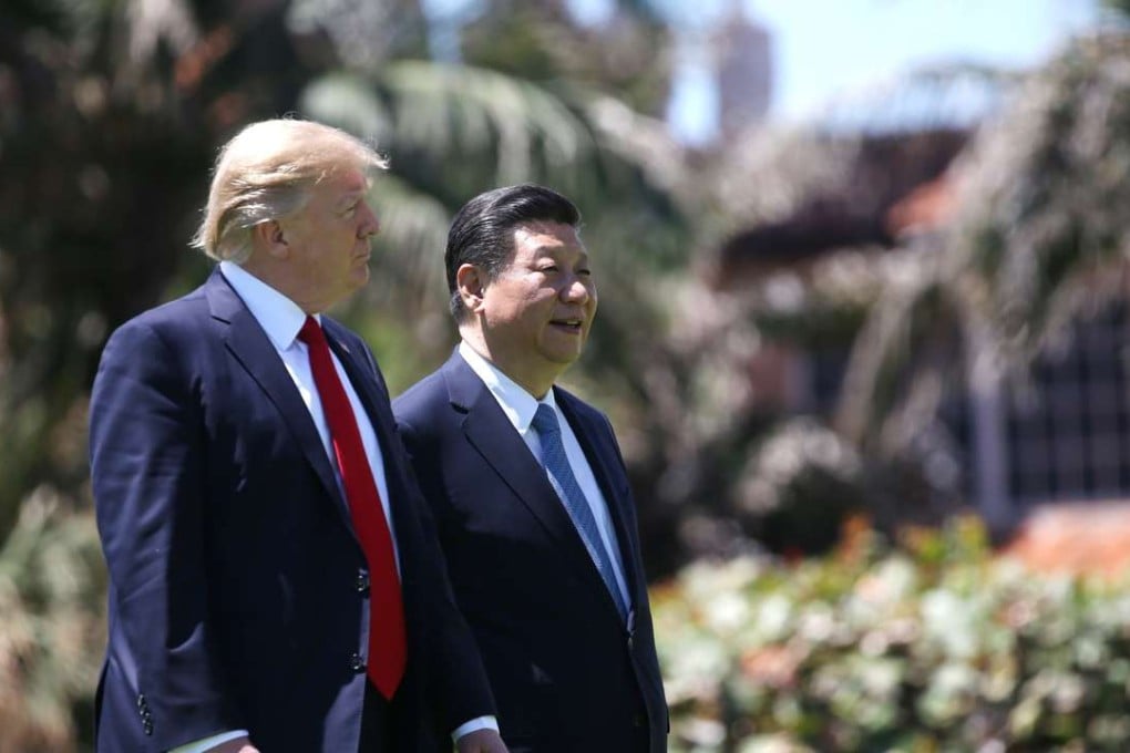US President Donald Trump and China's President Xi Jinping walk along the front patio of the Mar-a-Lago estate after a bilateral meeting in Palm Beach, Florida, on Thursday. Photo: Reuters