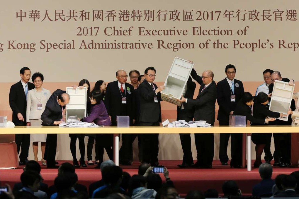 The Chairman of the Electoral Affairs Commission, Justice Barnabas Fung Wah (Centre) opens ballot box at Hong Kong Chief Executive Election. Photo: Sam Tsang