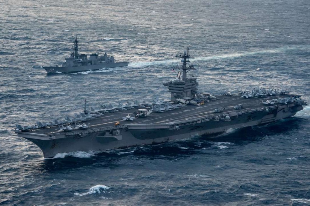 The aircraft carrier USS Carl Vinson (CVN 70), foreground,as it transits the East China Sea with the Japan Maritime Self-Defence Force Murasame-class destroyer JS Samidare (DD 106) on March 9, 2017. A US Navy carrier strike group was moving toward the Korean peninsula as the United States boosts its defences against North Korea’s nuclear ambitions. File Photo: AFP