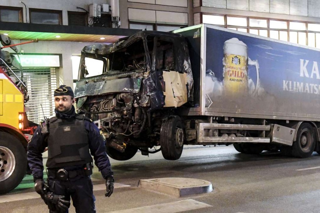 Tow trucks move the beer truck that crashed into the Ahlens department store after ploughing down Drottninggatan Street in central Stockholm, Sweden. Photo: EPA