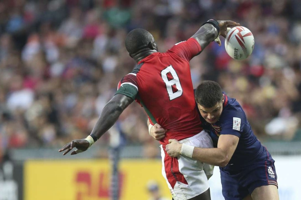 Kenya’s Andrew Amonde is tackled by Bobby Beattie from Scotland in the Bowl final. Photo: Dickson Lee