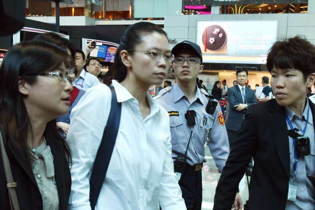 Li Ching-yu (centre), the wife of Taiwanese human rights activist Li Ming-che, at the airport in Taiwan. Photo: CNA