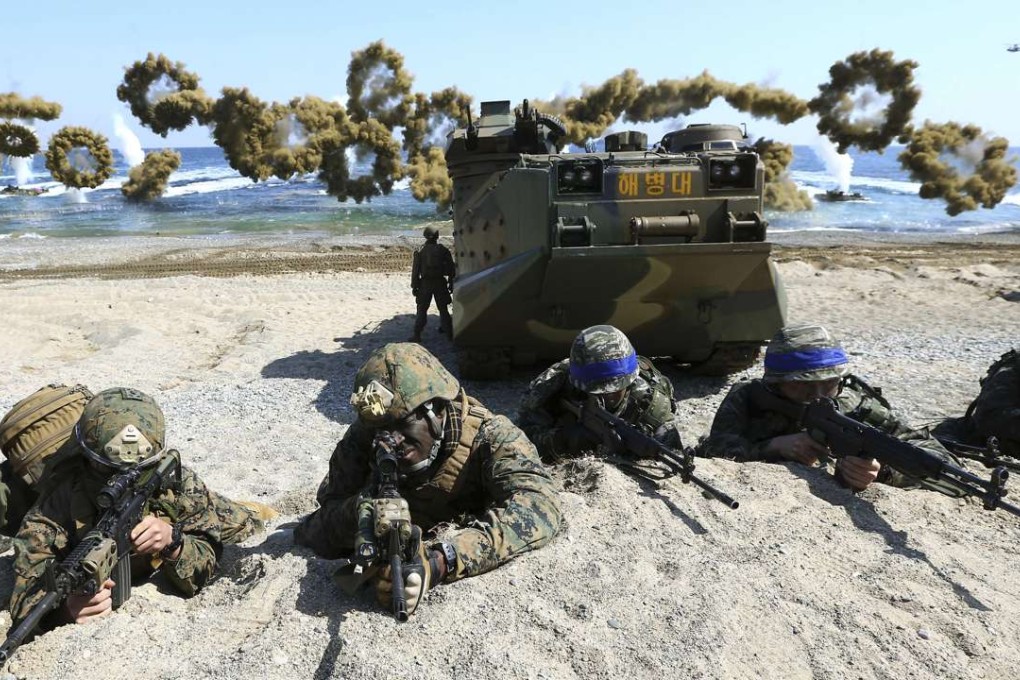 US and South Korean marines take positions after landing on a beach during military exercises in Pohang, South Korea. Photo: Yonhap