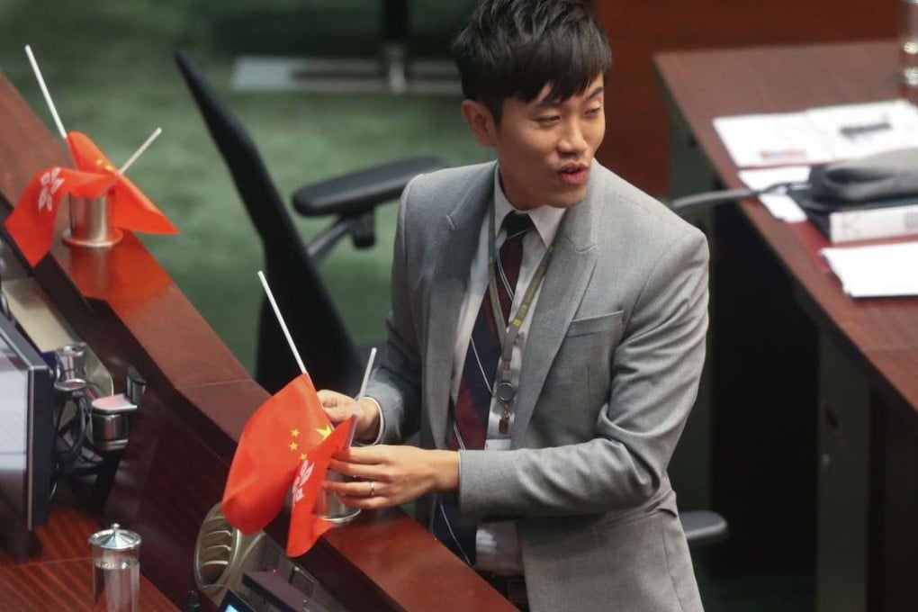 Legislator Cheng Chung-tai turns national and Hong Kong flags upside down. Photo: K. Y. Cheng