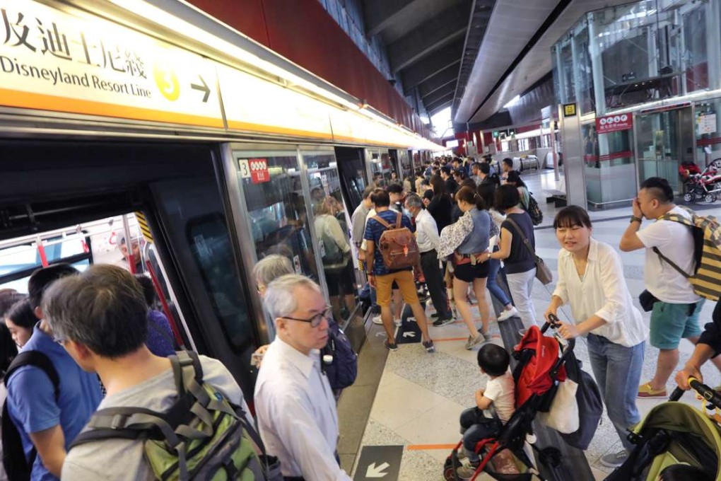 Commuters change lines between the Tung Chung and Disneyland Resort routes at Lai King MTR station. Photo: Felix Wong