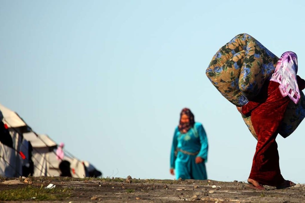 A Syrian woman carries a mattress at a temporary refugee camp in the village of Ain Issa, which houses people who fled Islamic State’s Syrian stronghold in Raqa. Syria lies in ruins. The total death toll lies somewhere between 320,000 and 470,000. More than 10 million people have been driven from their homes; half of them have fled abroad. Photo: AFP