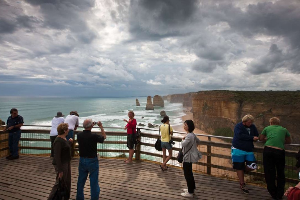 Tourists on a board walk at the Twelve Apostles in South West Victoria, the most famous sight on Australia’s Great Ocean Road. Photo: Alamy