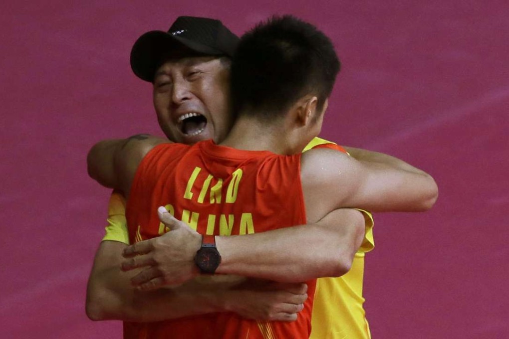 Chinese badminton ace Lin Dan is hugged by coach Li Yongbo while celebrating singles badminton gold medal at the 2012 Olympics. Li has left his post as team head. Photos: AP