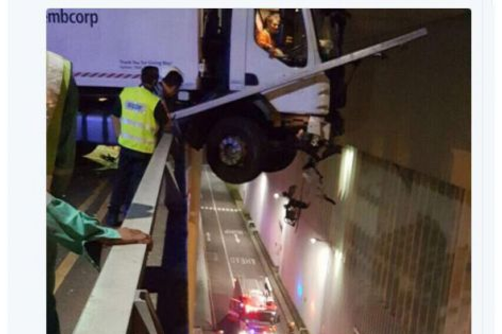 Screenshot taken from Twitter showing a Sembcorp garbage truck hanging over a ramp. Photo: Social media