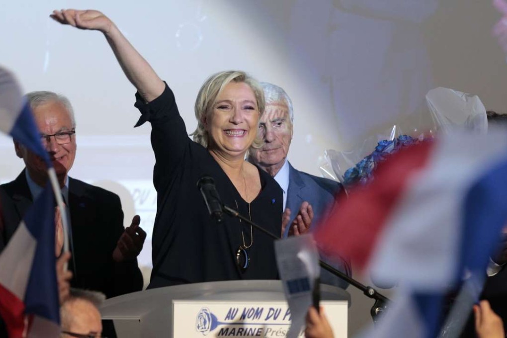 French far-right Front National (FN) presidential party Marine Le Pen waves to supporters after delivering a speech during a campaign meeting at the Palais des Congres in Ajaccio on the French Mediterranean island of Corsica,. Photo: AFP