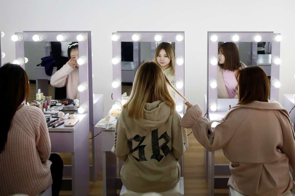 Girls attend a make-up training session at live-streaming talent agency Three Minute TV in Beijing in February. The company also arranges for employees to have cosmetic surgery at partner hospitals and small bank loans for the procedure. Photo: Reuters