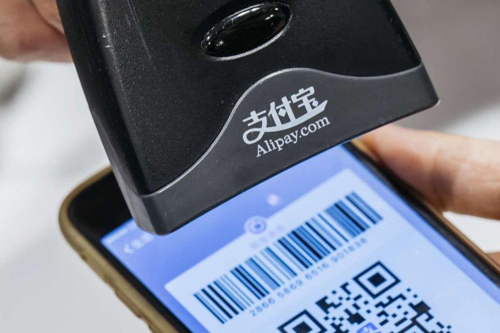 An employee scans a quick response (QR) code displayed on Ant Financial's Alipay app. Photo: Bloomberg