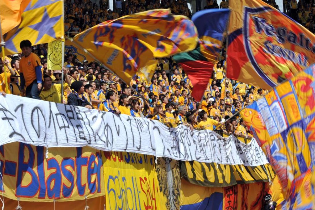 Supporters of Vegalta Sendai with a banner saying “We will not lose until we rebuild” during a Vegalta's first home game after the disaster, on April 29, 2011. Photo: AFP