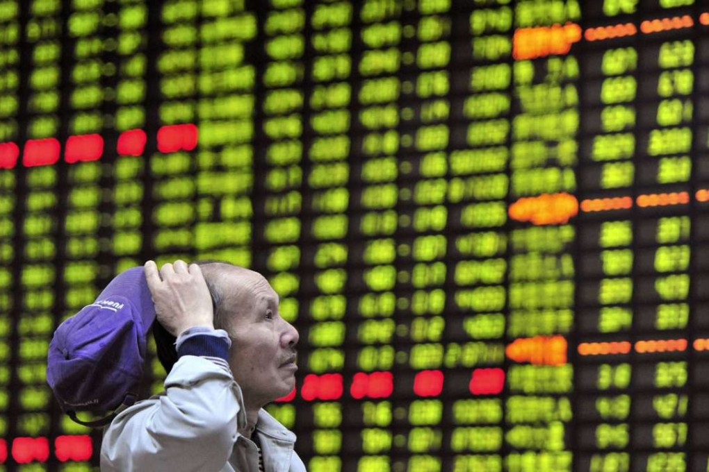 An investor looks at an electronic board showing stock information at a brokerage house in Jiujiang, Jiangxi province. Contrary to global norms, China’s stock exchanges use green to convey positive changes. Photo: Reuters