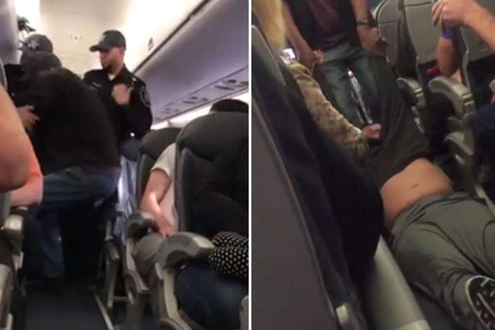 Officers drag David Dao through the cabin of a United Airlines flight from Chicago after he was chosen at random to leave the overbooked flight but refused to give up his seat. Photo: Twitter