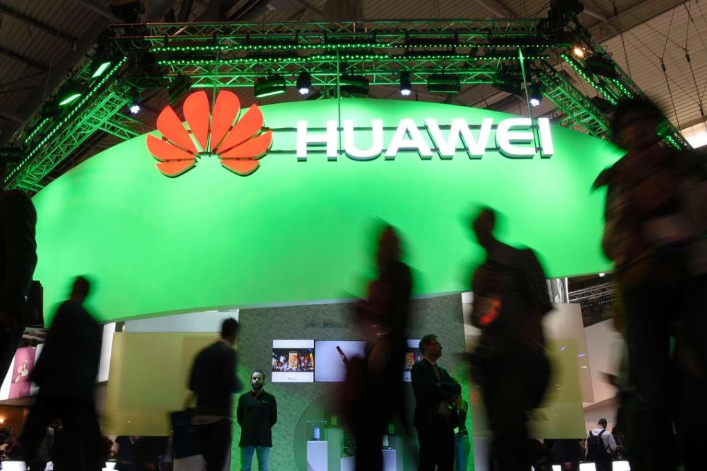 Visitors pass in front of the Huawei's stand on the first day of the Mobile World Congress in Barcelonaon on February 27, 2017 in Barcelona. Phone makers will seek to seduce new buyers with artificial intelligence functions and other innovations at the world's biggest mobile fair starting today in Spain. Photo: AFP