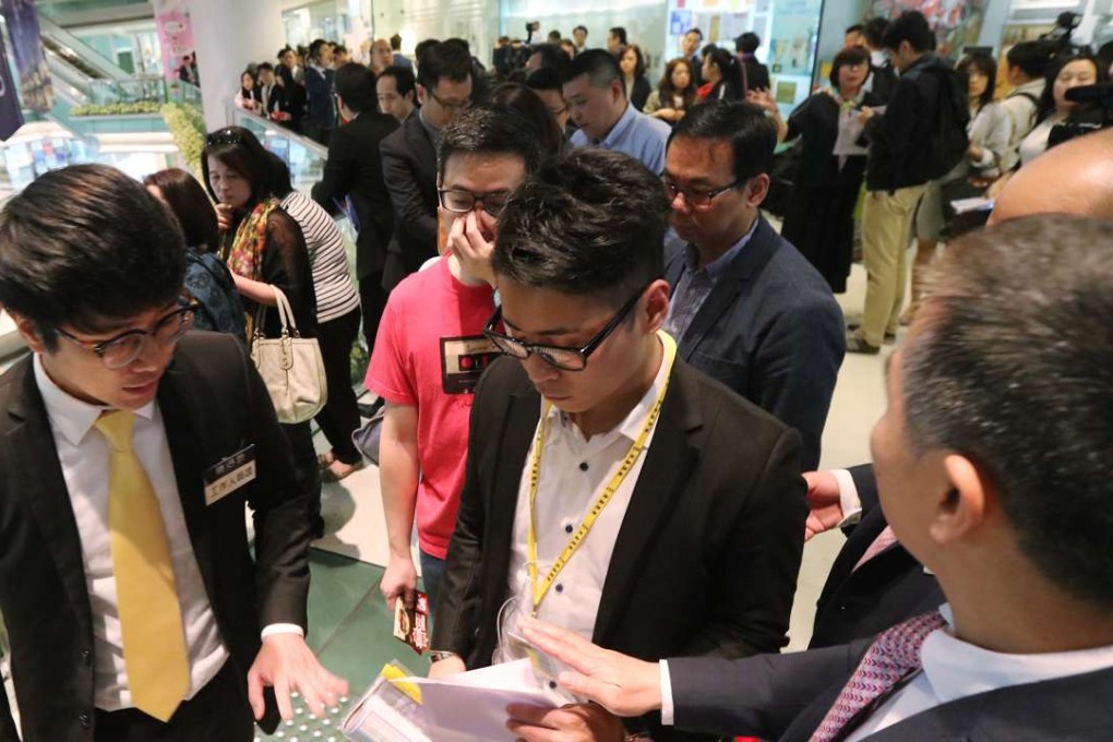 As many as 900 buyers registered to bid for 152 apartment units put on the market by Cheung Kong Property Holding. The developer sold 142 units of the Harbour Glory project within four hours. An estimated 30 per cent of the buyers showed up in groups, buying multiple units but under different names to work around a government stamp duty.Photo: Felix Wong