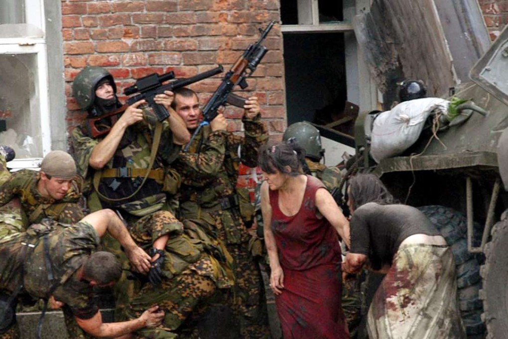 Russian special forces take cover during the rescue operation of Beslan's school. File photo: AFP