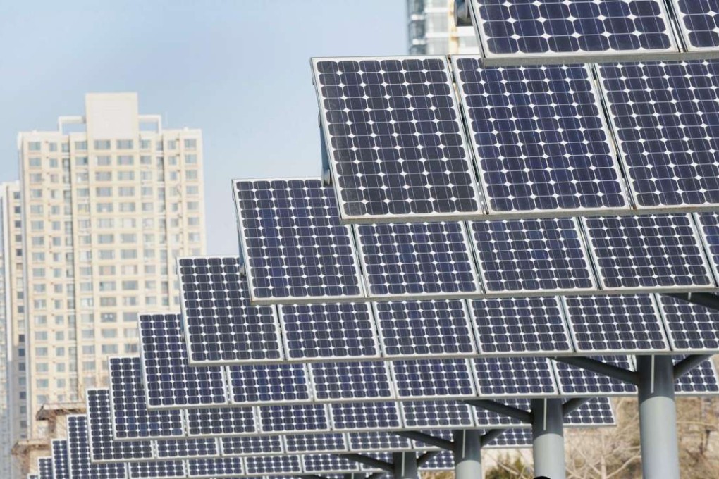 Residents walk past a line of solar power panels installed for public electricity supply in the Liaoning provincial capital of Shenyang. Photo: AFP PHOTO