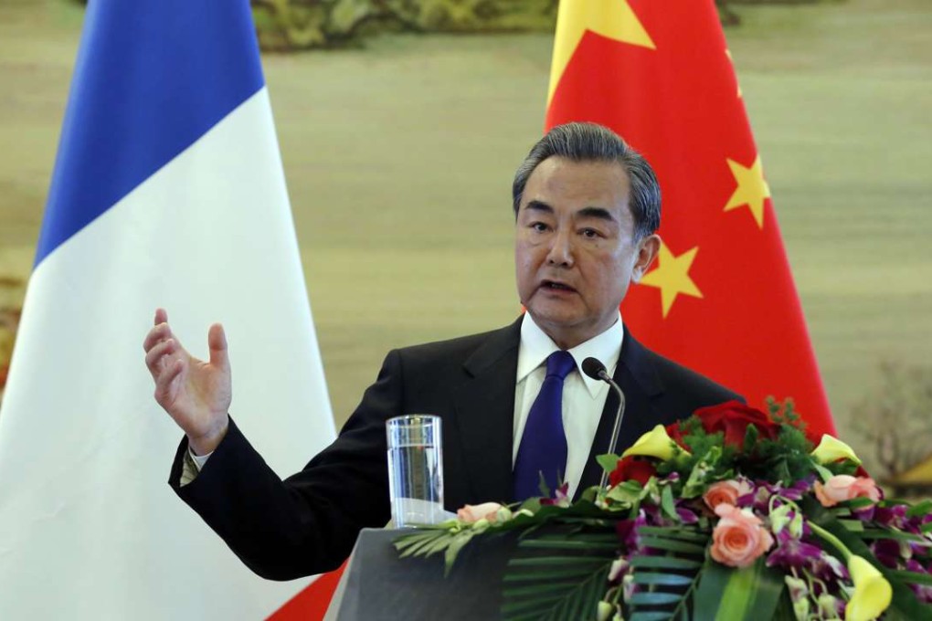 Chinese Foreign Minister Wang Yi at a joint news conference with French Foreign Minister Jean-Marc Ayrault (unseen) at the Ministry of Foreign Affairs in Beijing on Friday. Photo: EPA