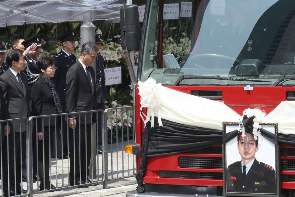 Chief Executive-elect Carrie Lam Cheng Yuet-ngor (third from left) and Chief Executive Leung Chun-ying (fourth from left) pay their last respects to firefighter Yau Siu-ming. Photo: Nora Tam