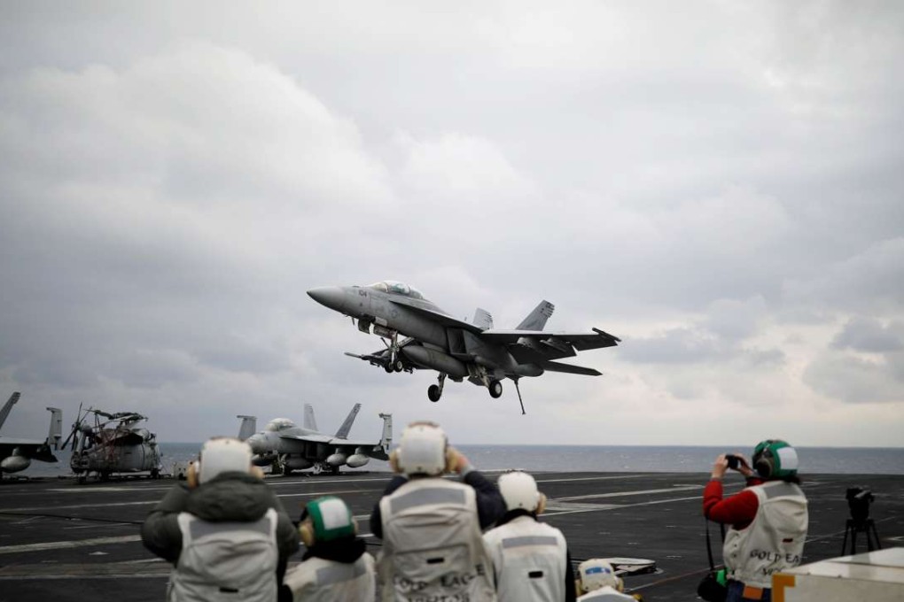 A US F18 fighter jet lands on the deck of US aircraft carrier USS Carl Vinson. Photo: Reuters