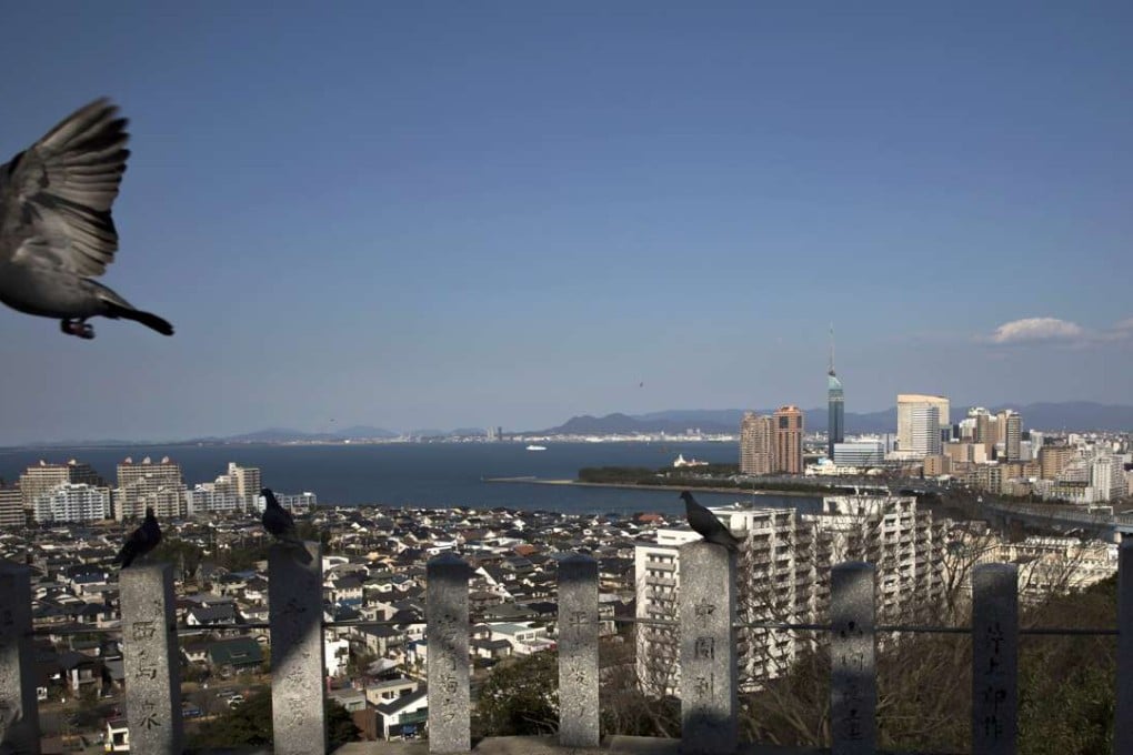 Hemmed in by mountains and its seaside location, Fukuoka is a compact city with average office rents half those in Tokyo and the lure of beaches nearby. Photo: Bloomberg