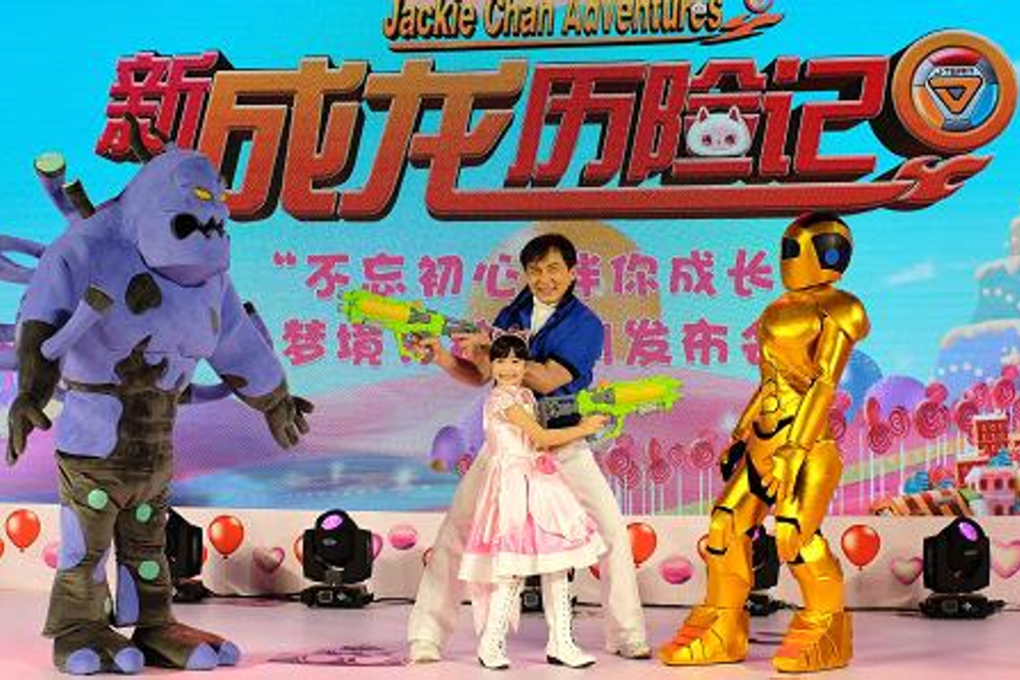 Jackie Chan poses for photographs with young celebrity Kyana "Poppy" Downs as they launch the "All New Jackie Chan Adventures" cartoon series, at a news conference in Beijing, April 13, 2017. Photo: CNBC/Barry Huang