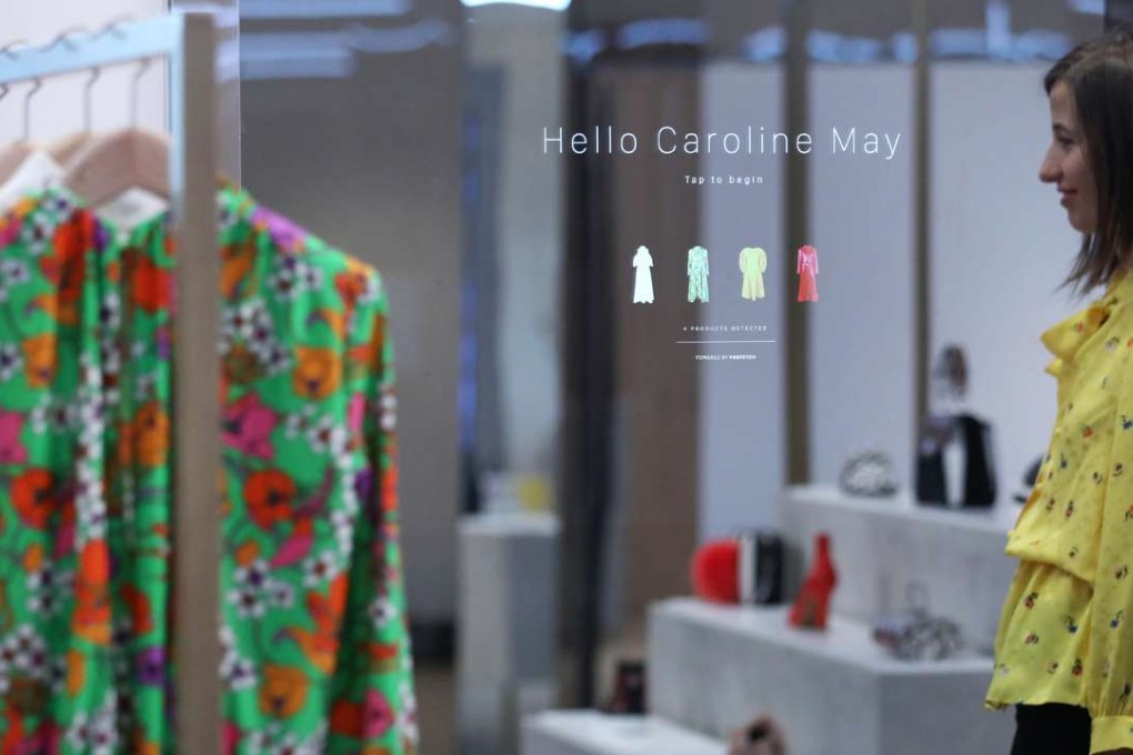 A touch screen mirror displays a welcome message and a consumer's product choices at Farfetch UK’s “Store of the Future” pop-up exhibition in London. Photo: Bloomberg