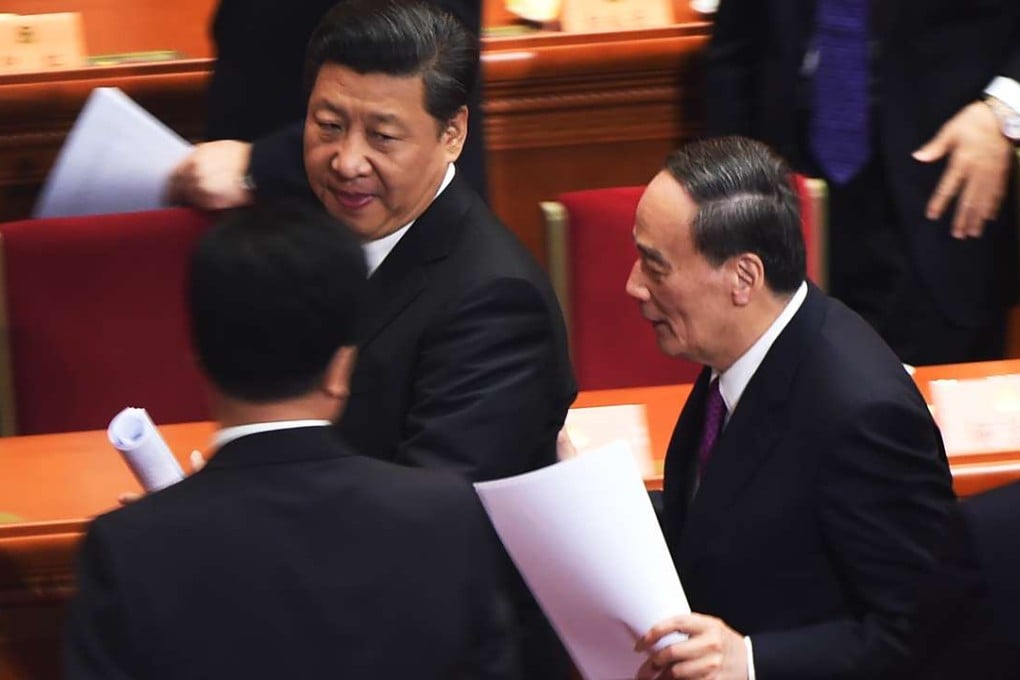 President Xi Jinping (left) and Politiburo Standing Committee member Wang Qishan (right) leave the opening session of the Chinese People's Political Consultative Conference meeting at the Great Hall of the People in Beijing in March last year. Photo: AFP