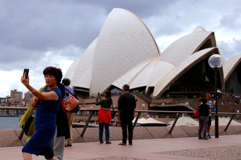 A Chinese tourist poses in front of the Sydney Opera House in Australia in March. According to the UN’s World Tourism Organisation, China’s international tourism expenditure last year hit US$261 billion, a rise of 12 per cent from 2015. Photo: Reuters