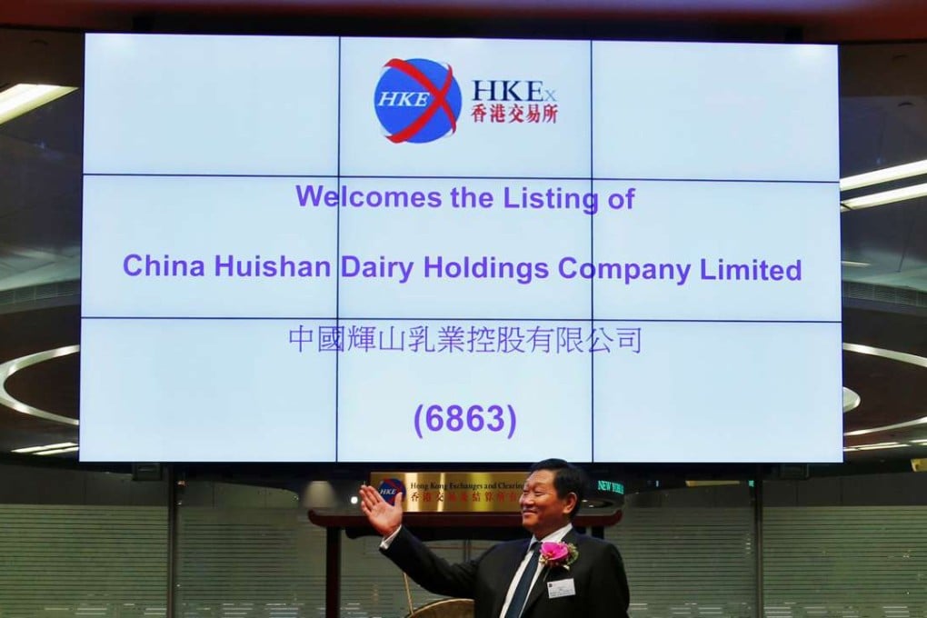 Yang Kai, chairman of Huishan Dairy, takes part in a ceremony during the debut of the company at the Hong Kong Exchange in September 2013. Photo: Reuters