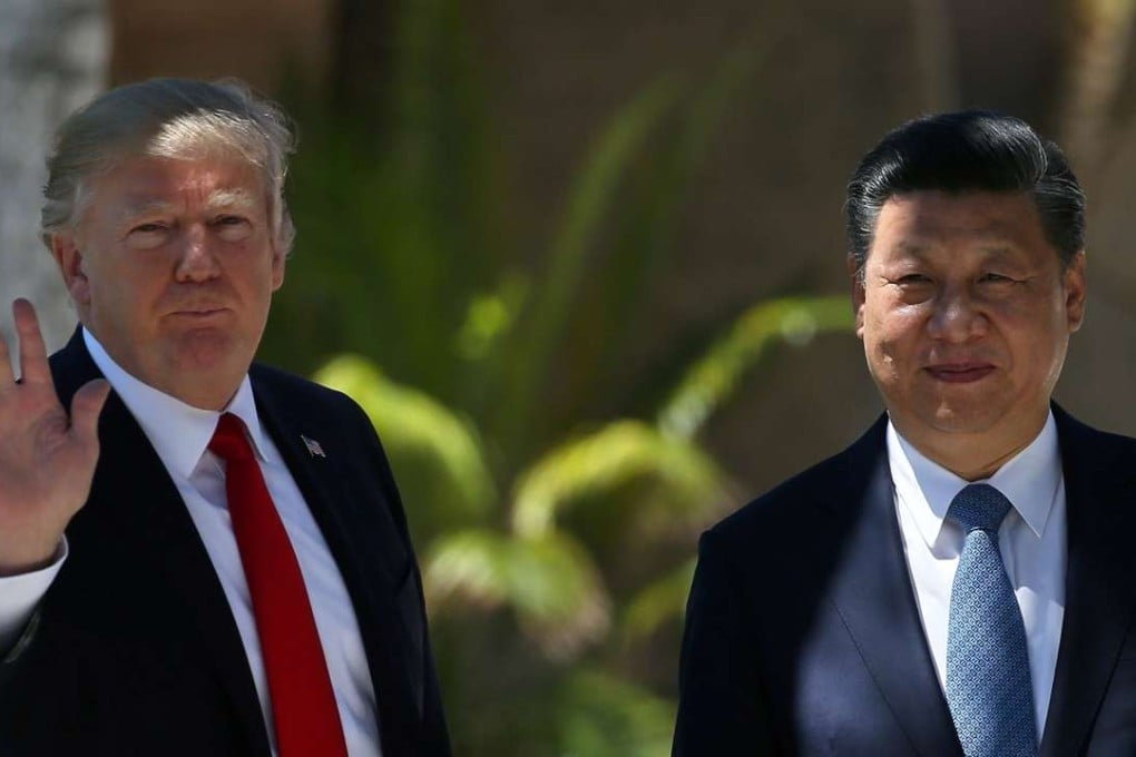 US President Donald Trump waves as he and China's President Xi Jinping walk along the front patio of the Mar-a-Lago estate. Trump’s administration formally declared that China and other trading partners were not currency manipulators. Photo: Reuters
