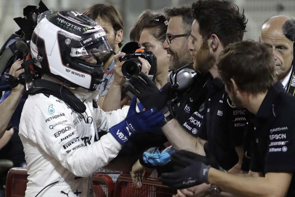 Mercedes driver Valtteri Bottas of Finland (left) celebrates with his mechanics after took pole position for the Bahrain Grand Prix. Photo: AP