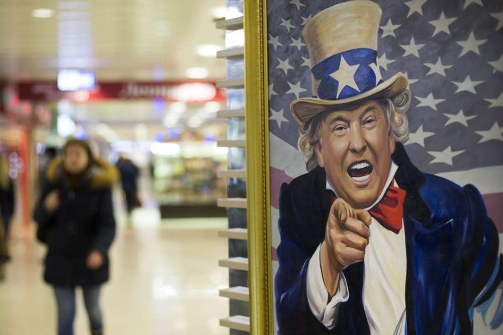 People walk past a caricature of US President Donald Trump on sale in a shopping mall in Moscow. Photo: AP