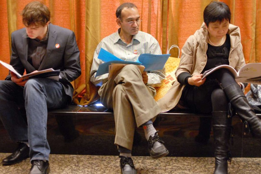 Foreigners attend a job fair in Beijing. A new visa policy bases qualifications at top talent, professional talent and unskilled worker levels. Handout photo