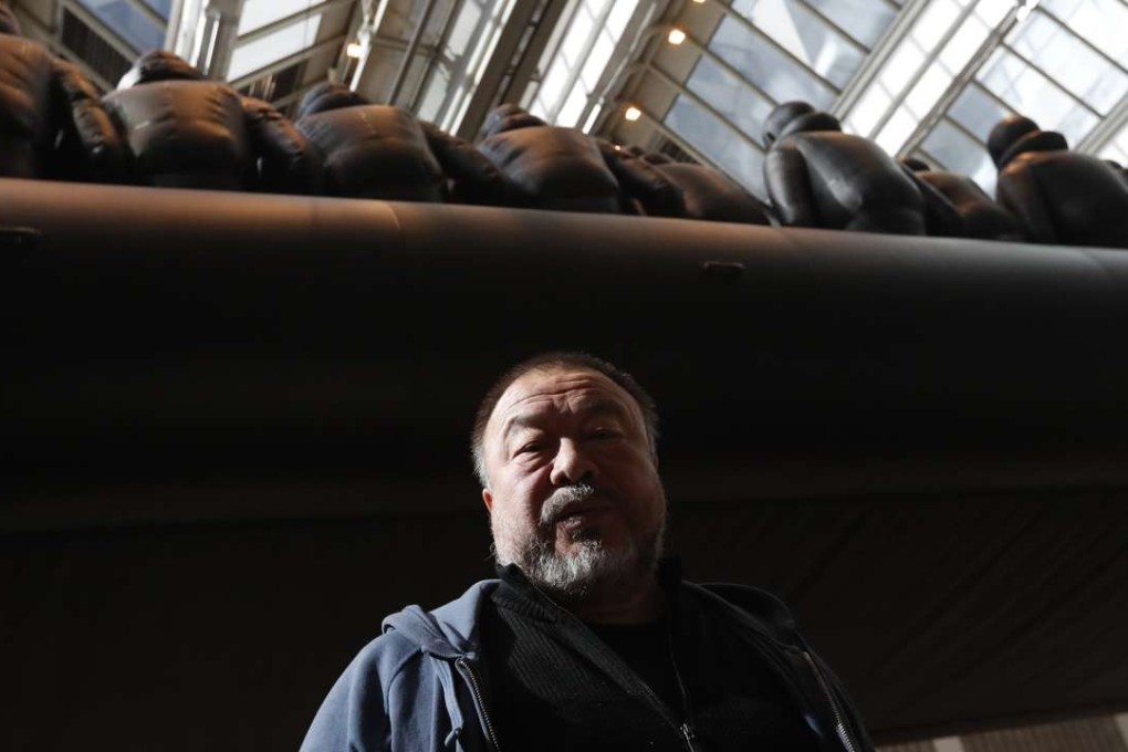 Chinese activist and artist Ai Weiwei poses by his installation displayed at the National Gallery in Prague, Czech Republic, in March. Photo: AP