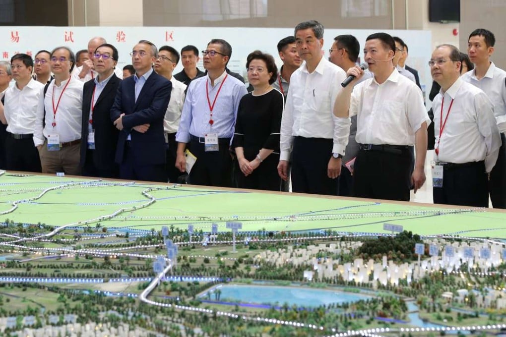 Hong Kong Chief Executive Leung Chun-ying (left of man with microphone) meets Nanshan government officials during his visit to Guangzhou, where he will discuss Beijing’s Greater Bay Area plan over a three-day tour. Photo: Dickson Lee