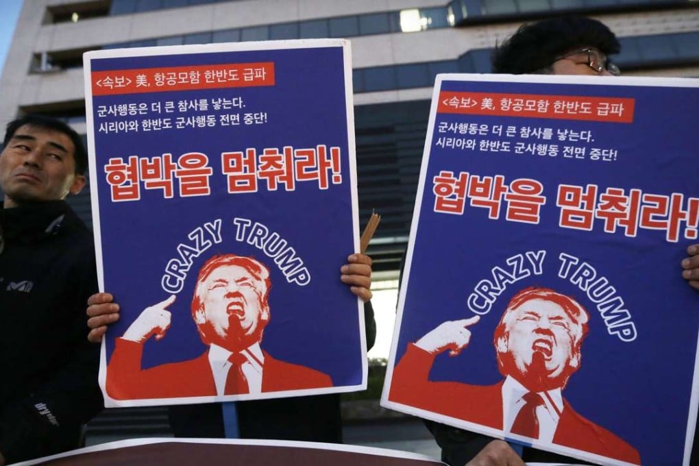 South Korean protesters hold images of US President Donald Trump during a rally denouncing the United States' policy against North Korea near the US. Embassy in Seoul on Wednesday. Photo: AP