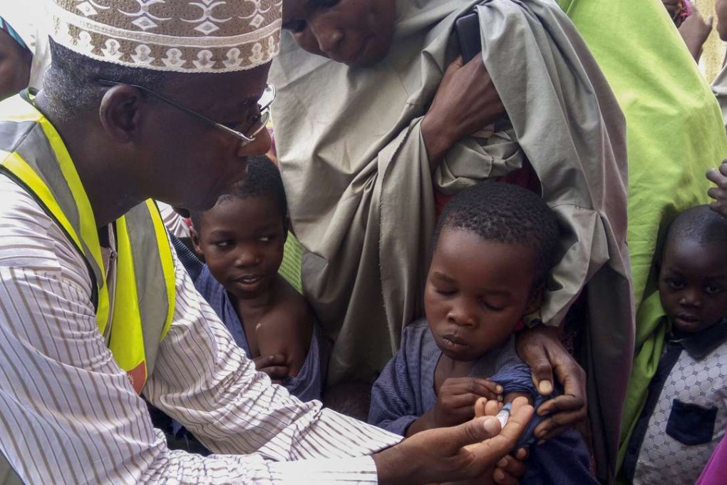 Nigerian Doctor Rilwanu Mohammed (L), Executive Secretary of the Federal capital Primary Health Care Development Board, vaccinates a resident for Meningitis in Dakwa village. Nigeria's Centre for Disease Control reports a meningitis outbreak as 15 states have been affected. Photo: EPA