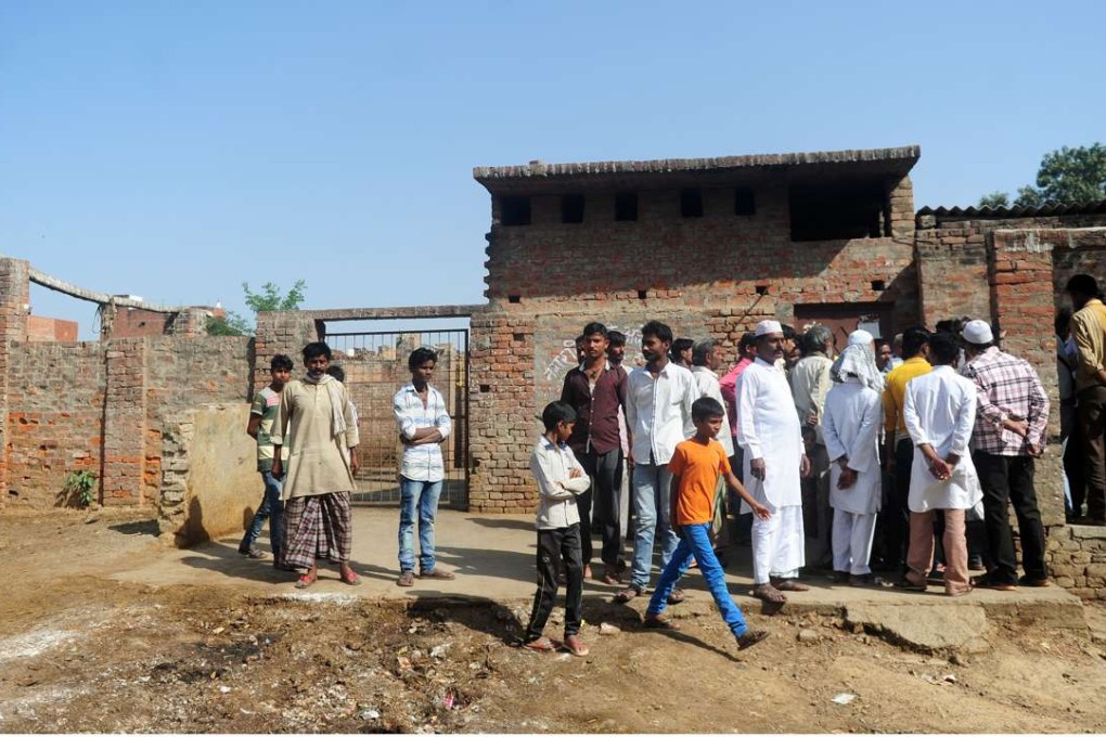 Muslim butchers and traders with family members gather outside a closed illegal slaughterhouse at Naini in Allahabad, India. Photo: AFP