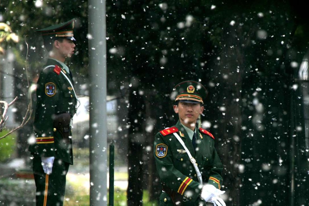 Chinese police officers stand guard in a cloud of flying catkins, or flower clusters, outside a foreign embassy in Beijing. The catkins, the blossoms of female poplar and willow trees, invade the city each spring, causing discomfort to people with allergies and even disrupting traffic due to reduced visibility. Photo: AP