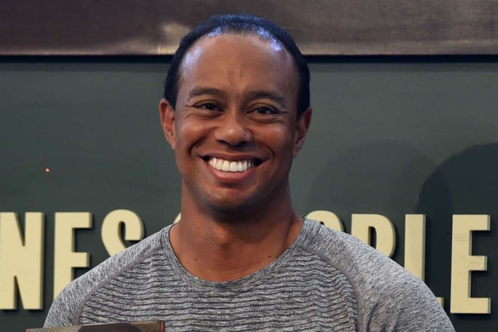 This file photo taken last month shows 14-time major champion golfer Tiger Woods holding a copy of his new book ''The 1997 Masters: My Story " before his book signing at Barnes & Noble's Union Square in New York. Woods announced on his website on April 20, 2017, that he has undergone a fourth back surgery to alleviate pain, one that likely sidelines him at least until October. Photo: AFP