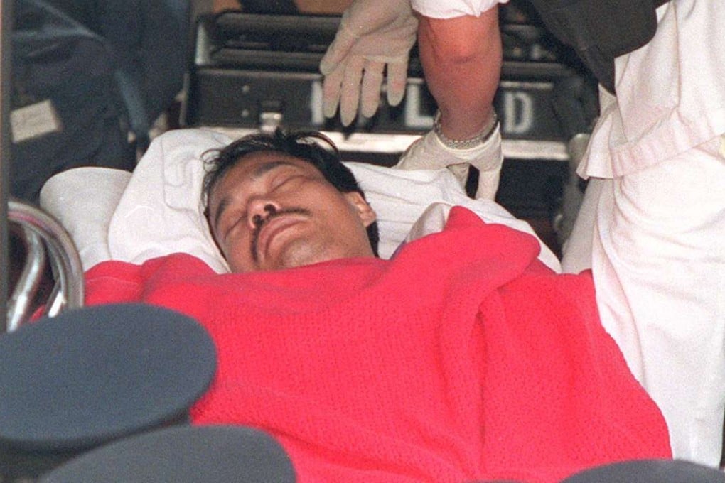 Yip Kai-foon loaded onto an ambulance on his way to Stanley Prison after he was finally caught in May 1996. Yip died this week from cancer at age 55. Photo: David Wong