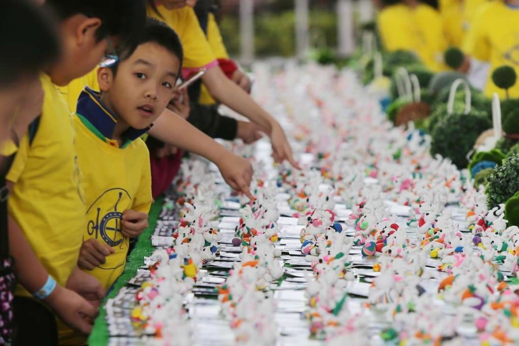 Children take a sculpting lesson at the Jockey Club Riding High Together Festival at the Sha Tin Racecourse on April 14. Photo: Xiaomei Chen