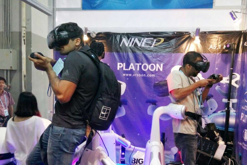 Visitors to the Canton Fair try virtual reality games at the NINED Digital Technology booth. Photo: Mimi Lau