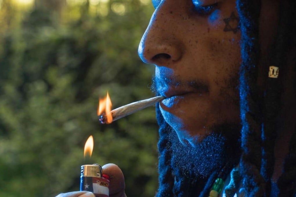 A volunteer working for a Washington group calling for cannabis to be removed from the Controlled Substances Act takes a break for a smoke after he and friends rolled hundreds and hundreds of marijuana joints in preparation for a protest at the US Capitol. Photo: AFP