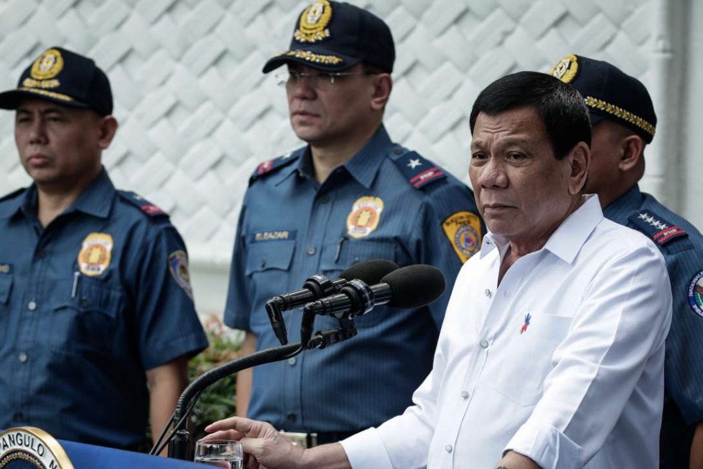 Philippine President Rodrigo Duterte flanked by police. Photo: EPA