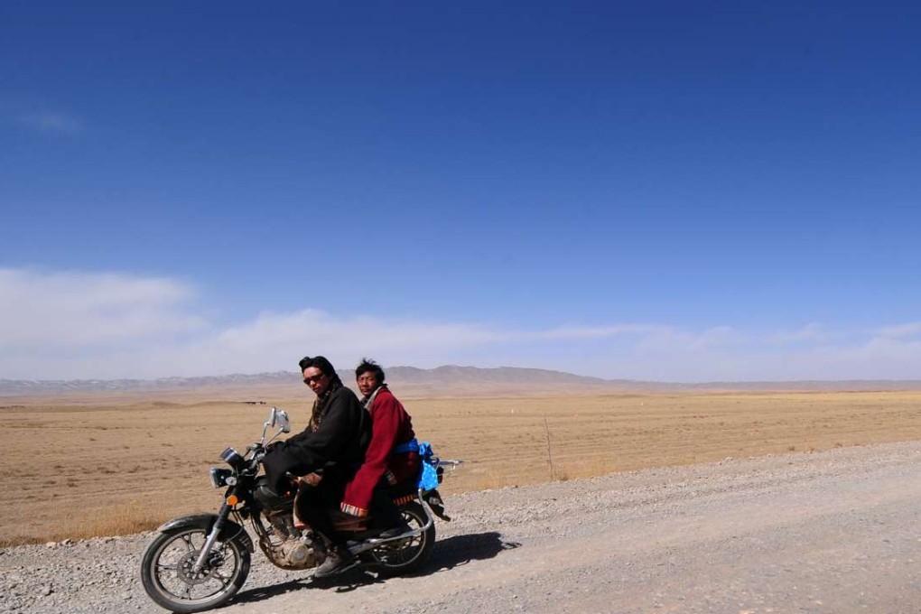 Tibetan nomads ride a motorcycle on the Tibetan plateau in Qinghai province. Photo: AFP
