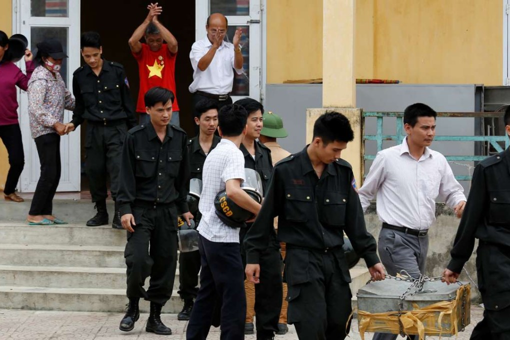 Hostages, who were originally held by villagers in a land dispute, walk out after the villagers released them in Dong Tam, outside Hanoi, Vietnam. Photo: Reuters